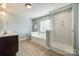Bright bathroom with a bathtub and walk-in shower at 5716 Langwell Ln, Charlotte, NC 28278