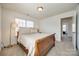 A well-lit bedroom featuring a wooden sleigh bed, bedside table, and two windows at 5716 Langwell Ln, Charlotte, NC 28278