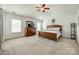 Primary bedroom featuring a vaulted ceiling, a bed, dresser, and two windows at 5716 Langwell Ln, Charlotte, NC 28278