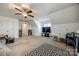 A spacious bonus room featuring built-in bookcases, a television and neutral decor at 5716 Langwell Ln, Charlotte, NC 28278