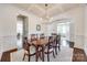 Bright dining room with coffered ceiling and a large wood table with seating for six at 5716 Langwell Ln, Charlotte, NC 28278