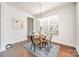 Formal dining room with a modern chandelier, wooden floors, and natural light at 5716 Langwell Ln, Charlotte, NC 28278