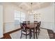 Formal dining room with coffered ceiling, chandelier, and large table at 5716 Langwell Ln, Charlotte, NC 28278