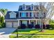 Charming two-story brick home with a manicured lawn and inviting curb appeal on a sunny day at 5716 Langwell Ln, Charlotte, NC 28278