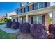 Inviting front porch with brick facade and lush, purple bushes on a sunny day at 5716 Langwell Ln, Charlotte, NC 28278