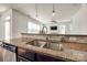 View of the kitchen sink and countertops with lighting fixtures overlooking the Gathering room at 5716 Langwell Ln, Charlotte, NC 28278