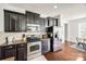 This kitchen has stainless steel appliances, granite countertops, and wooden cabinets at 5716 Langwell Ln, Charlotte, NC 28278