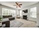 This living room offers neutral paint, a fireplace, lots of natural light, and a ceiling fan at 5716 Langwell Ln, Charlotte, NC 28278