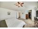 Spacious main bedroom with a ceiling fan, neutral carpet, and walk-in closet at 5716 Langwell Ln, Charlotte, NC 28278