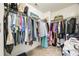 Walk-in closet with an abundance of hanging storage space and upper shelves at 5716 Langwell Ln, Charlotte, NC 28278