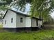 The back exterior of the house showing the siding, yard, and back entrance at 59 Pine St, Great Falls, SC 29055