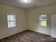 Bedroom featuring two windows for natural light and a doorway at 59 Pine St, Great Falls, SC 29055