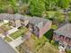 Aerial view of a two-story brick home with a two-car garage, red shutters, and a green lawn at 620 Millstream Dr, Rock Hill, SC 29732