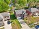 Aerial view of a charming brick home with a two-car garage, red shutters and lush landscaping at 620 Millstream Dr, Rock Hill, SC 29732