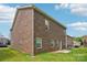 Two-story brick home with a well-maintained lawn and lush greenery in the backyard at 620 Millstream Dr, Rock Hill, SC 29732