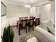 Elegant dining room boasts a wooden table set for eight, with wainscoting and seamless access to the living area at 620 Millstream Dr, Rock Hill, SC 29732
