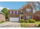 Charming two-story brick home with a well-maintained lawn, purple shutters, and a two-car garage at 620 Millstream Dr, Rock Hill, SC 29732