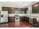 Well-lit kitchen with stainless appliances, dark cabinets, and granite countertops at 620 Millstream Dr, Rock Hill, SC 29732