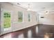 Bright living room with wood floors, several windows providing natural light, and access to the backyard at 620 Millstream Dr, Rock Hill, SC 29732