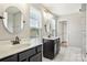 Bright bathroom featuring dual vanities, round mirrors, and a window offering natural light at 620 Millstream Dr, Rock Hill, SC 29732