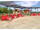 Lounge at the lake park with red loungers, concession stand, grassy space, and shade structures at 620 Millstream Dr, Rock Hill, SC 29732
