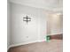 Image shows a wall with a TV mount and a doorway to another room with hardwood floors at 620 Millstream Dr, Rock Hill, SC 29732