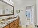 Bathroom featuring wood cabinets, granite counters, decorative mirror, and toilet and shower at 633 Elmhurst Dr, Fort Mill, SC 29715