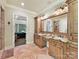 Spacious primary bathroom with dual vanities, tile flooring, and a view into the bedroom at 633 Elmhurst Dr, Fort Mill, SC 29715