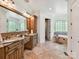 This bathroom offers a double vanity, a soaking tub, and neutral tiles throughout at 633 Elmhurst Dr, Fort Mill, SC 29715