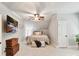Cozy bedroom features neutral colors, a ceiling fan, and a wall-mounted TV for comfortable living at 633 Elmhurst Dr, Fort Mill, SC 29715