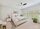 Bright bedroom featuring a ceiling fan, plantation shutters, and neutral decor at 633 Elmhurst Dr, Fort Mill, SC 29715