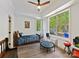 Bedroom with large windows, ceiling fan, wood floors, and decorated with toys at 633 Elmhurst Dr, Fort Mill, SC 29715