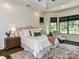 Bright bedroom features a large bed, bedside table, and sitting area with ample natural light from large windows at 633 Elmhurst Dr, Fort Mill, SC 29715