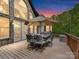 Enjoy outdoor dining on this spacious deck, featuring a table with seating and a large umbrella at 633 Elmhurst Dr, Fort Mill, SC 29715