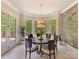 Bright dining room with a modern chandelier, large windows, and access to the outdoor deck at 633 Elmhurst Dr, Fort Mill, SC 29715