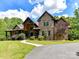 Charming two-story brick home with lush landscaping, a covered porch, and a winding walkway at 633 Elmhurst Dr, Fort Mill, SC 29715