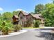 Beautiful two-story brick home featuring a circular driveway and lush landscaping, including roses and mature trees at 633 Elmhurst Dr, Fort Mill, SC 29715