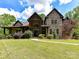 Stunning brick home with beautiful landscaping and a winding walkway leading to the front door at 633 Elmhurst Dr, Fort Mill, SC 29715