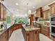 Spacious kitchen with custom wood cabinets, a large central island, granite countertops, and modern appliances at 633 Elmhurst Dr, Fort Mill, SC 29715