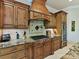Close-up of a kitchen showcasing custom cabinets, granite countertops, stainless steel appliances, and tile backsplash at 633 Elmhurst Dr, Fort Mill, SC 29715