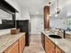 Kitchenette with granite countertops, wood cabinets, black appliances and stylish sink at 633 Elmhurst Dr, Fort Mill, SC 29715