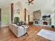 Spacious living room boasts a stone fireplace, hardwood floors, and abundant natural light at 633 Elmhurst Dr, Fort Mill, SC 29715