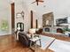 Cozy living room showcases a stone fireplace, wood beams, and large windows creating a warm and inviting atmosphere at 633 Elmhurst Dr, Fort Mill, SC 29715