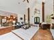 Bright and open living space featuring hardwood floors, a stone fireplace, and seamless access to the kitchen at 633 Elmhurst Dr, Fort Mill, SC 29715
