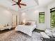 This main bedroom boasts an upholstered headboard, large windows, and access to ensuite bathroom at 633 Elmhurst Dr, Fort Mill, SC 29715