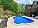 Backyard features in-ground pool with mature landscaping and a patio seating area at 633 Elmhurst Dr, Fort Mill, SC 29715