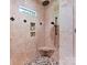 Tiled walk-in shower with rainfall shower head, bench, and tiled niche with accent tiles at 633 Elmhurst Dr, Fort Mill, SC 29715