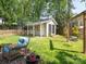 Backyard offers a relaxing space with sitting area, shed, fence, and swing at 653 Gable Oaks Nw Ln, Concord, NC 28027