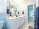 Bright bathroom features a double vanity, white cabinets, and modern fixtures at 653 Gable Oaks Nw Ln, Concord, NC 28027