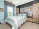 Comfortable bedroom with built-in storage, stylish wallpaper, and soft bedding, creating a cozy and functional space at 653 Gable Oaks Nw Ln, Concord, NC 28027